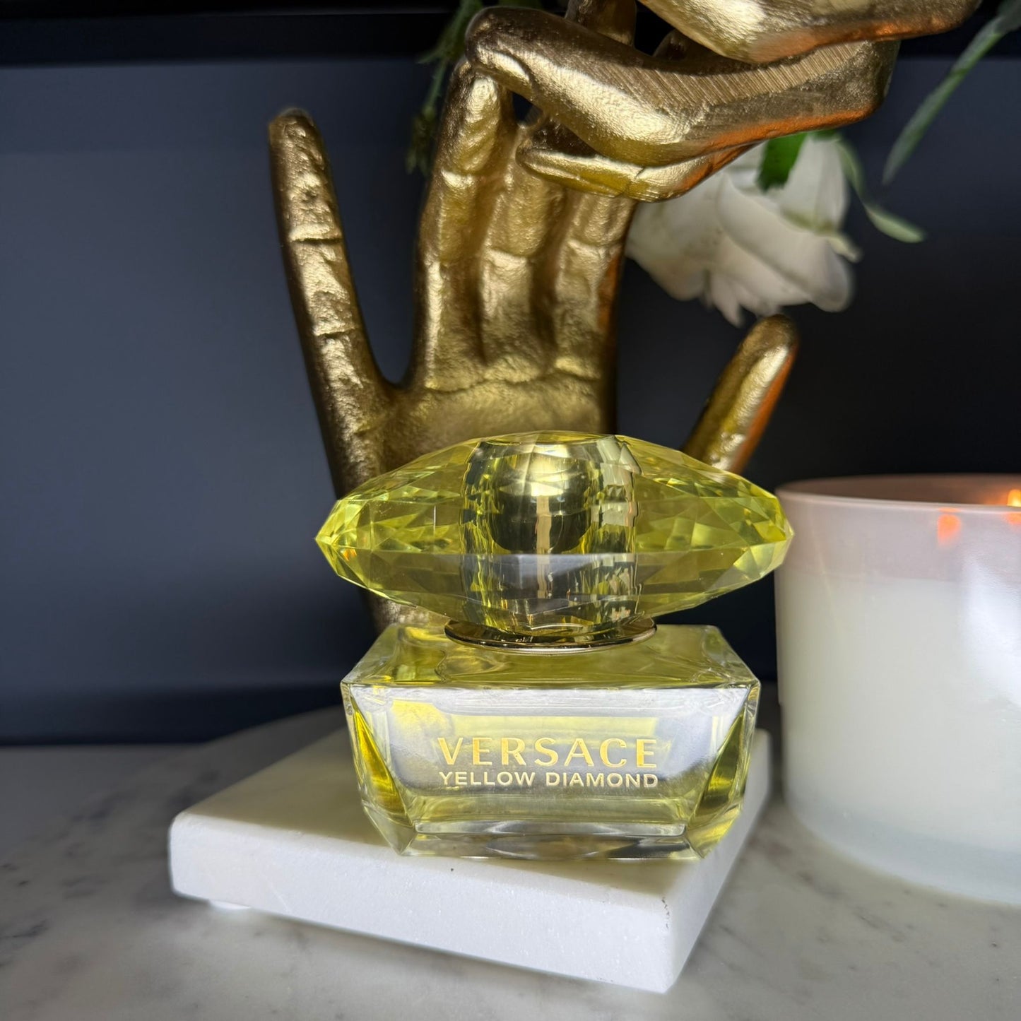 Authentic Versace Yellow Diamond perfume lifestyle photo with candle and gold decor