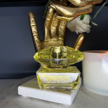 Authentic Versace Yellow Diamond perfume lifestyle photo with candle and gold decor